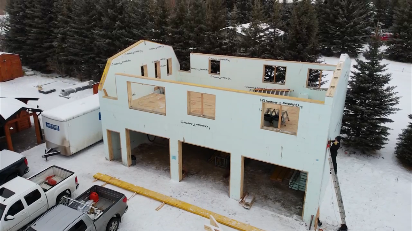 aerial view of icf home in winter with snow
