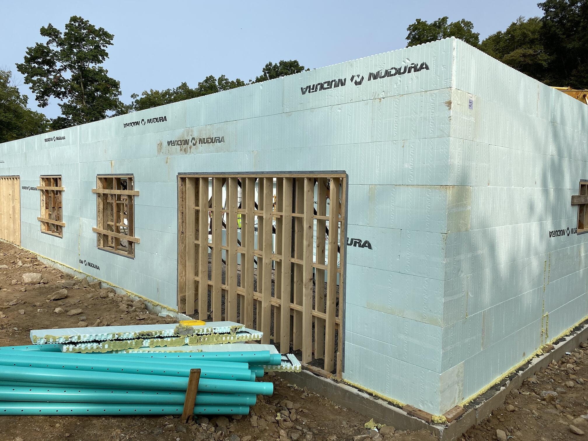 Photo of a structure being built using Nudura ICFs. The blocks stand about 12 feet high.