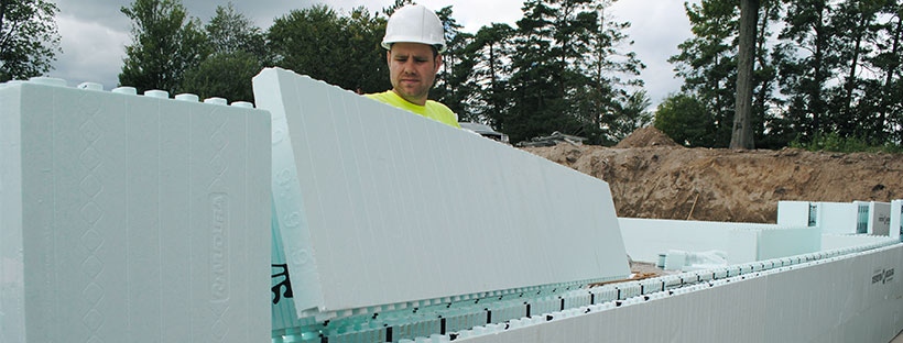 Contractor building a wall using Nudura ICFs