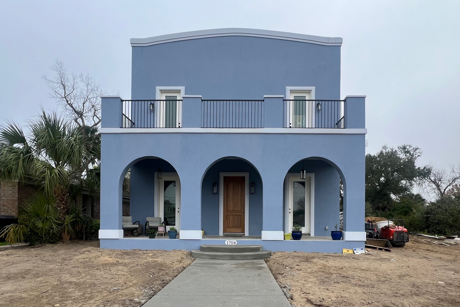 Light blue house with curved entryway.