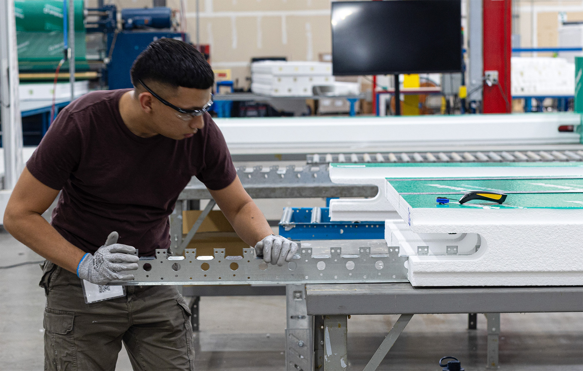 Individual assembling insulated concrete panel in a factory.